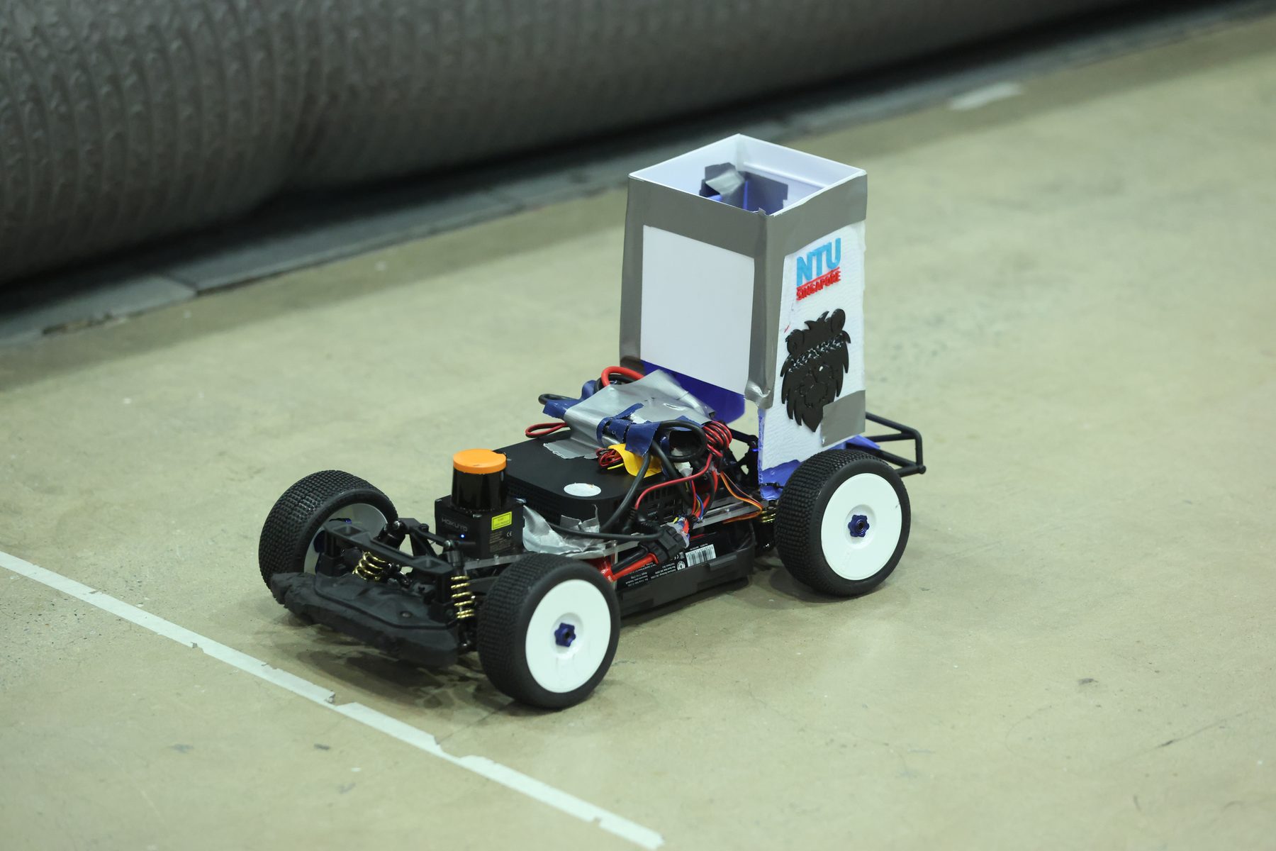 The DeepSpeed car running on the bare concrete floor of the Busan venue