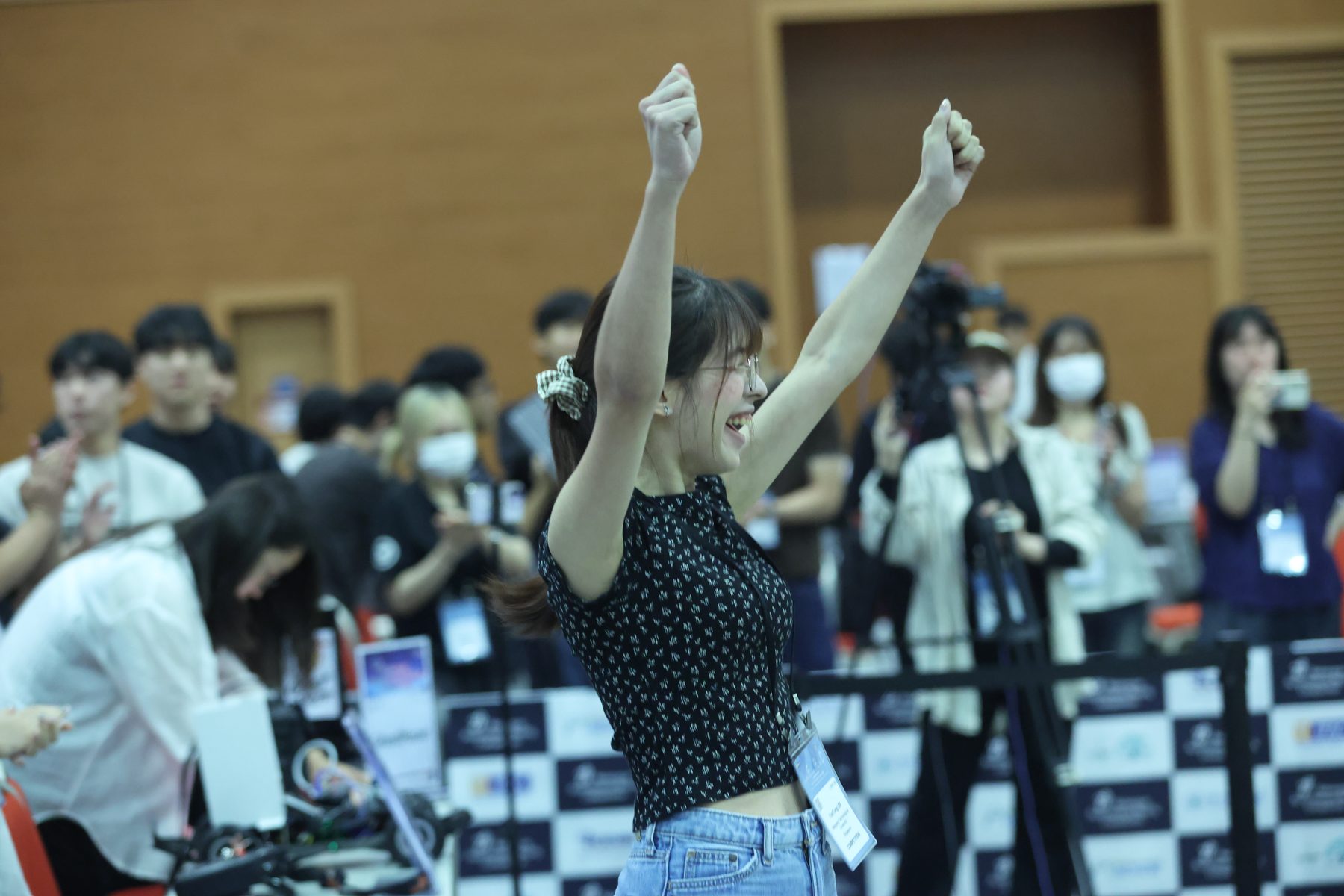 A DeepSpeed team member celebrating with both fists raised as the race is called